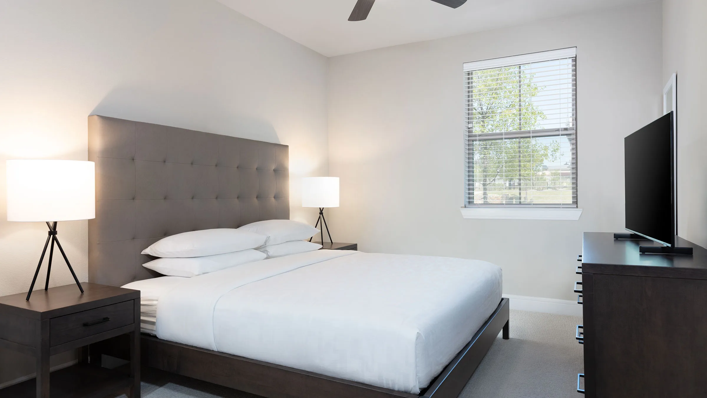 a bed with a lamp and a window