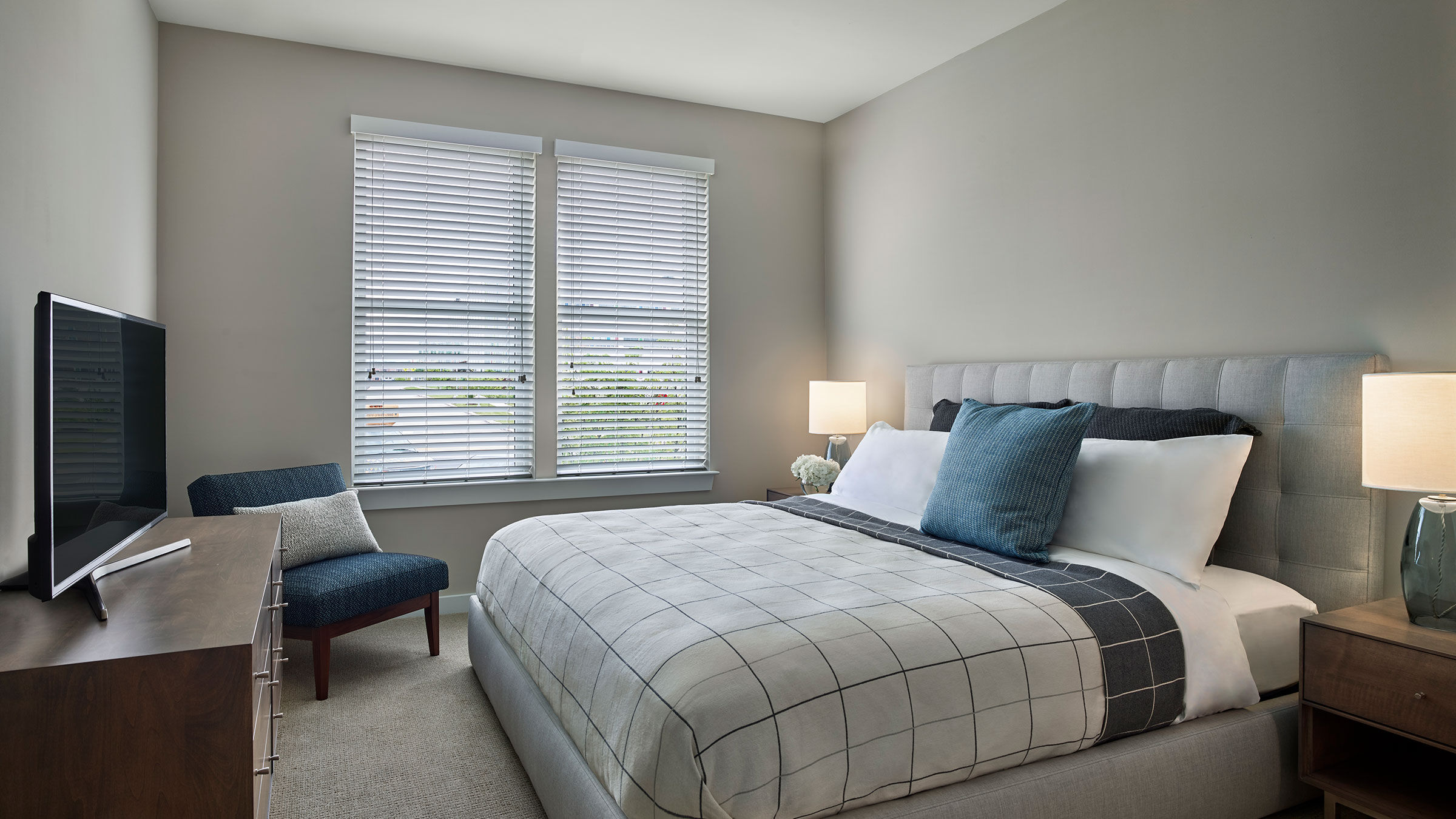 a bedroom with a bed and a chair