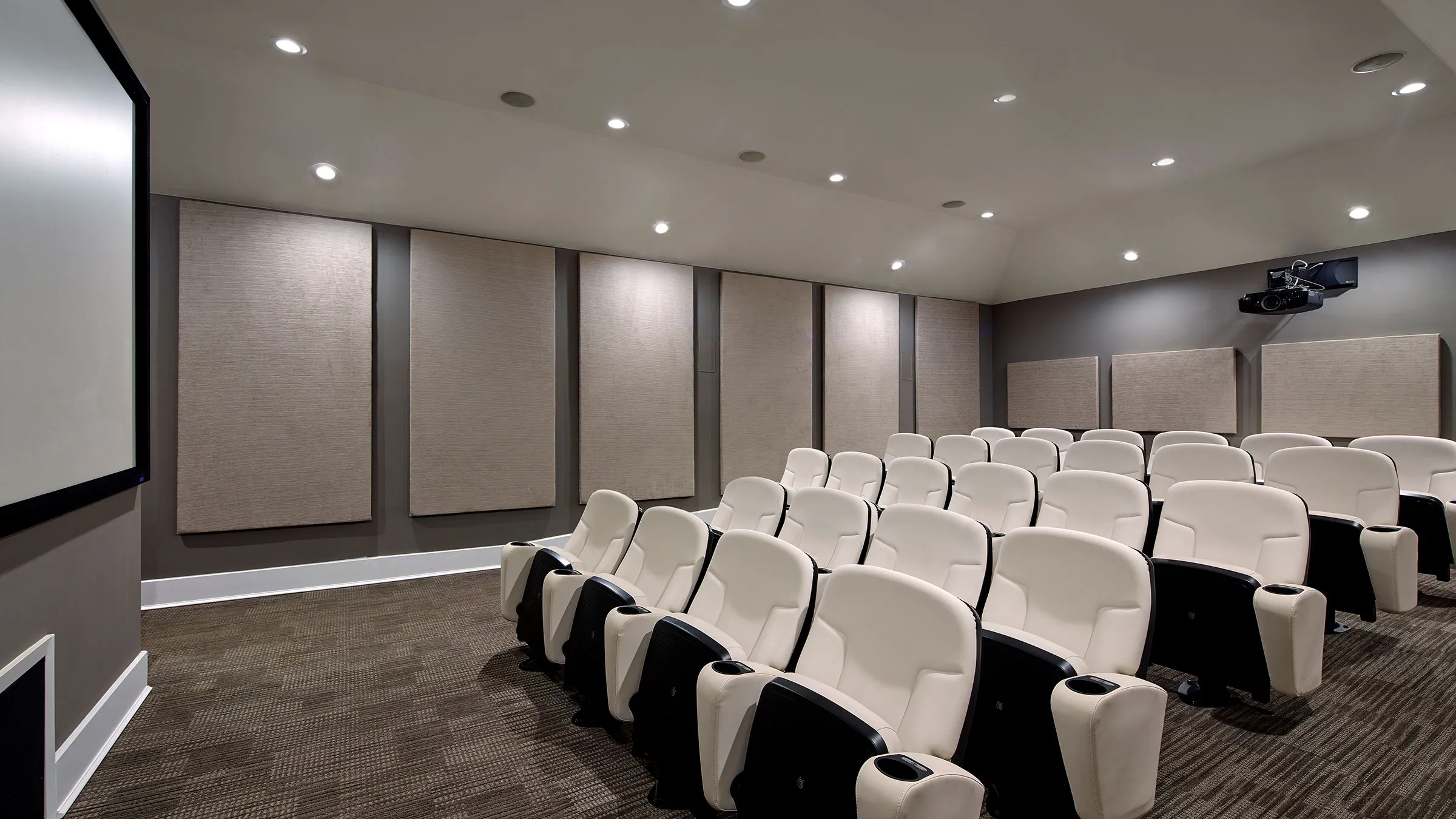 a room with white chairs and a wall of light