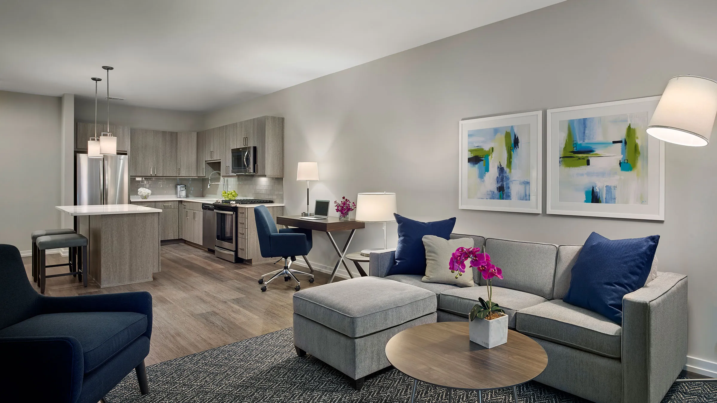 a living room with a couch and a kitchen