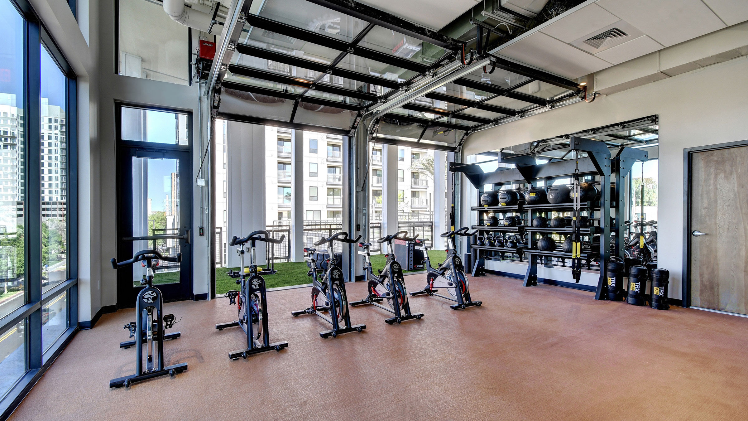 a room with exercise bikes and a garage door