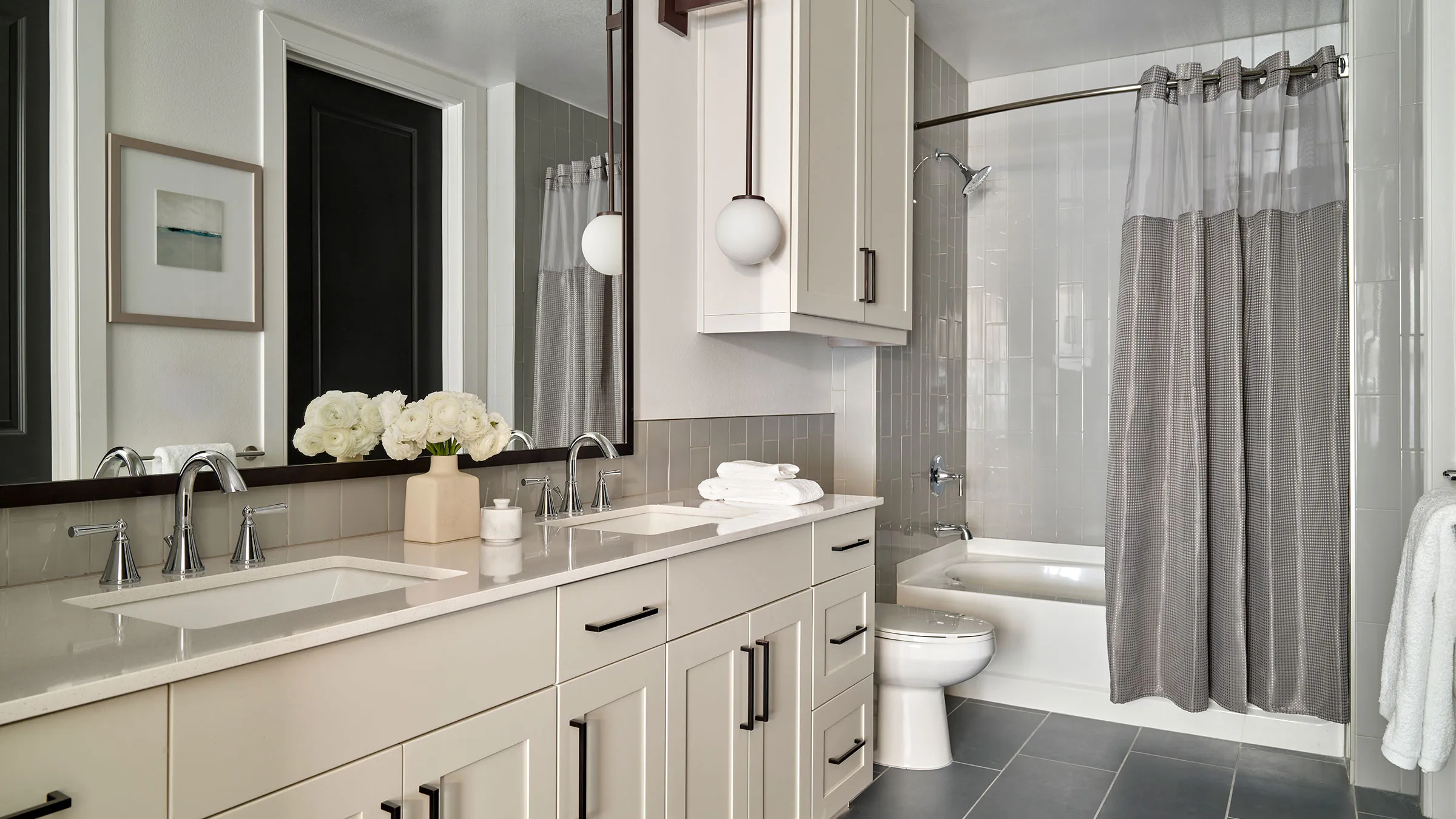 a bathroom with white cabinets and a toilet