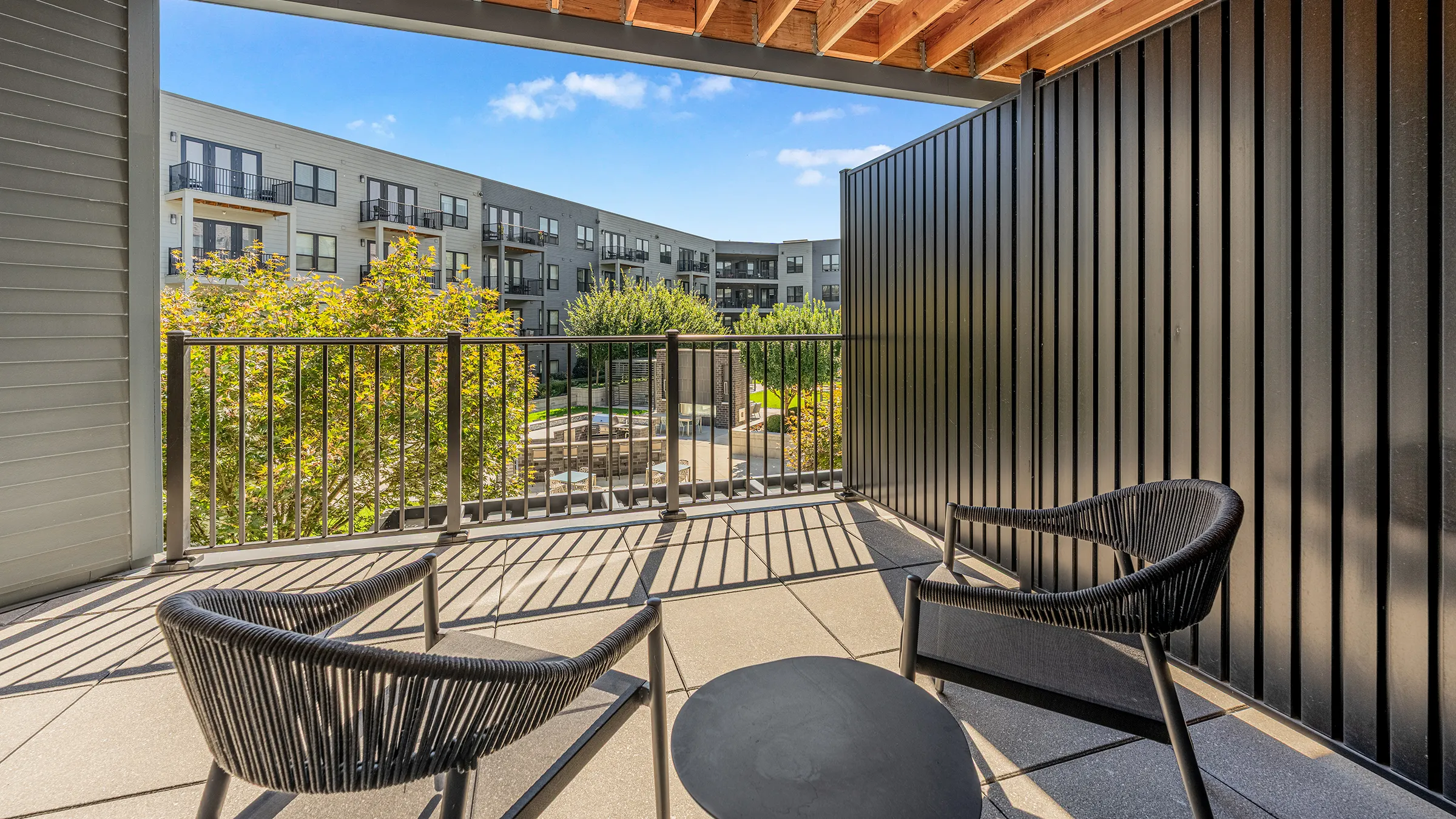 a patio with chairs and a table