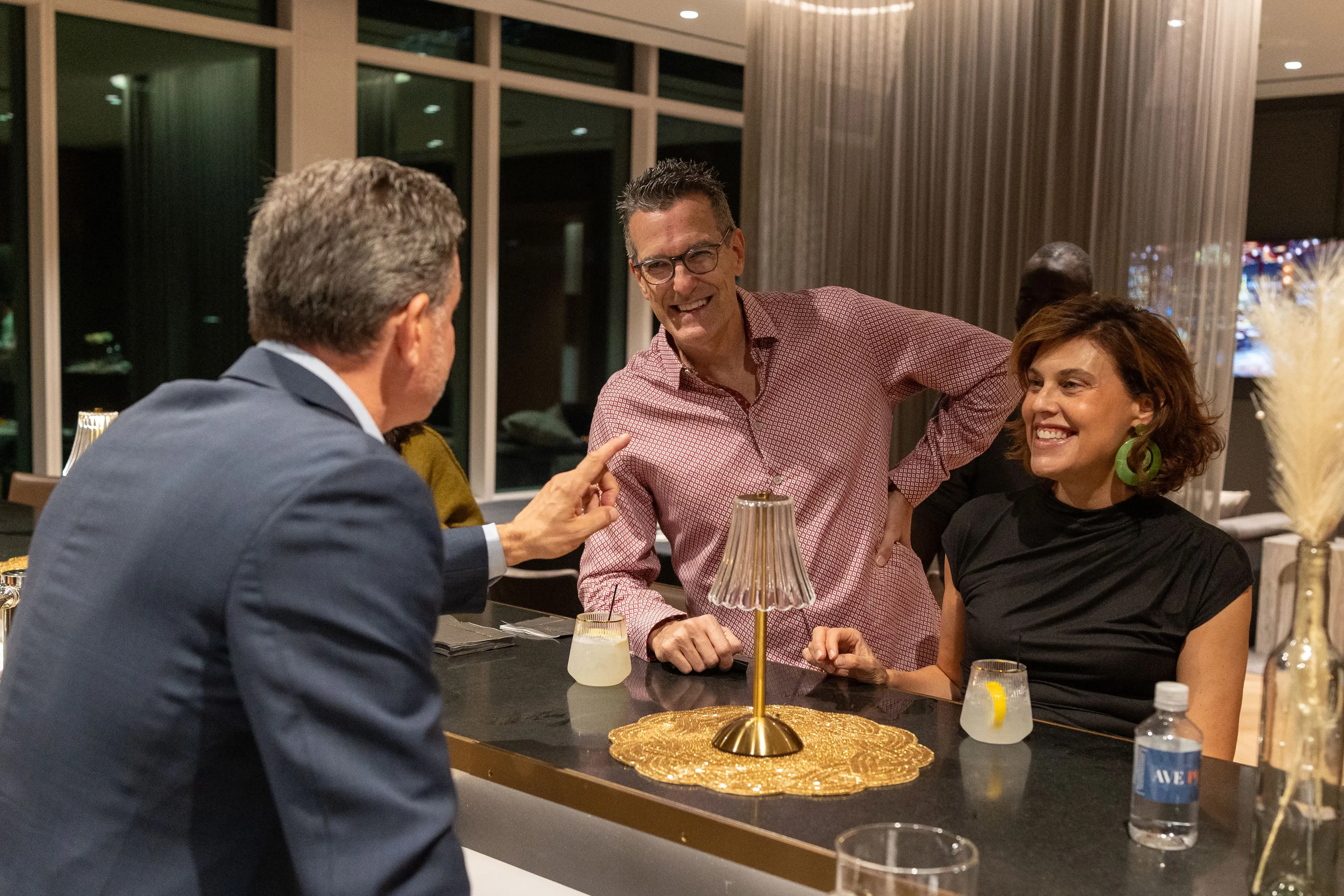 a group of people sitting at a bar