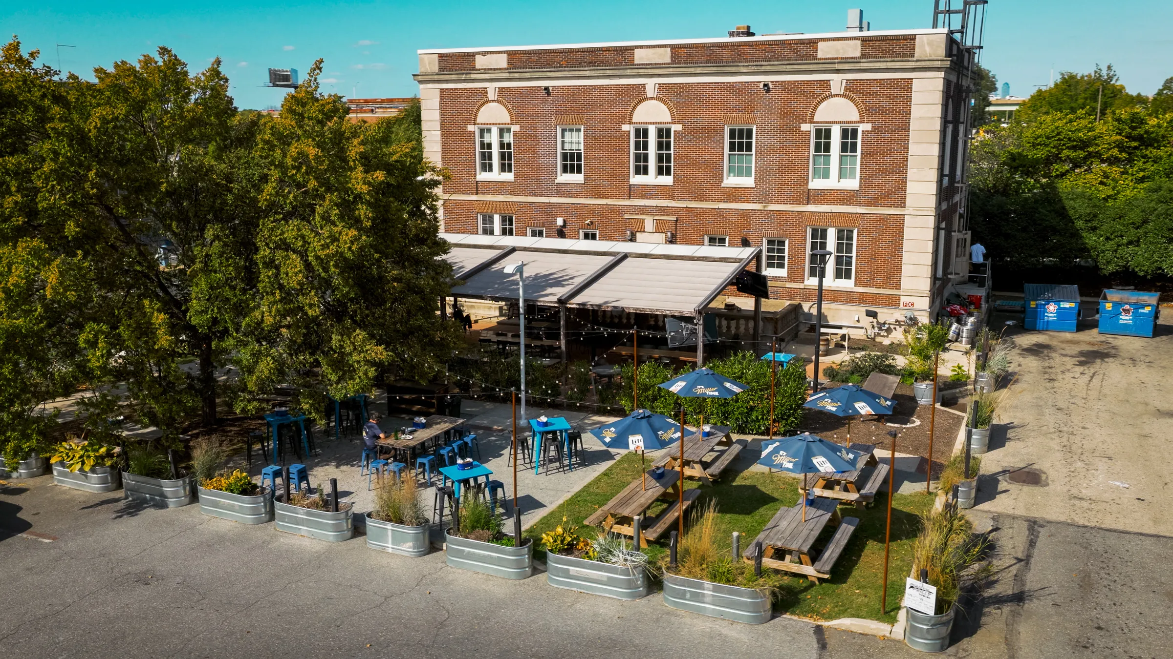 a building with tables and umbrellas