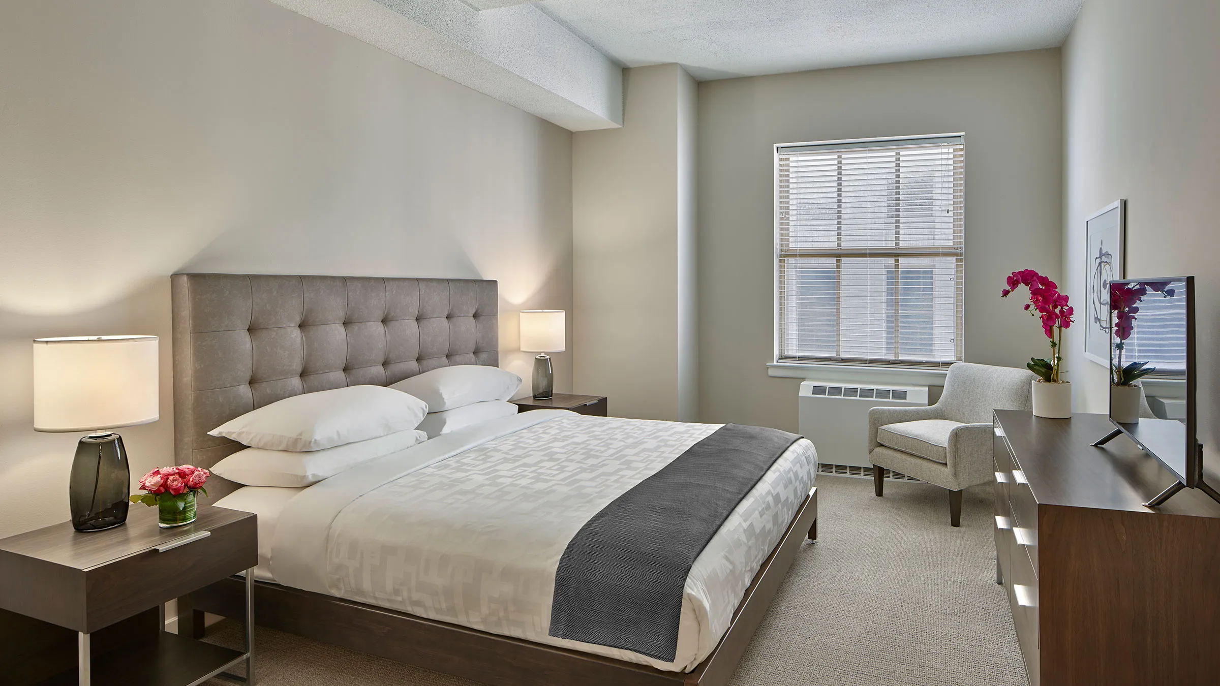 a bedroom with a bed and a chair