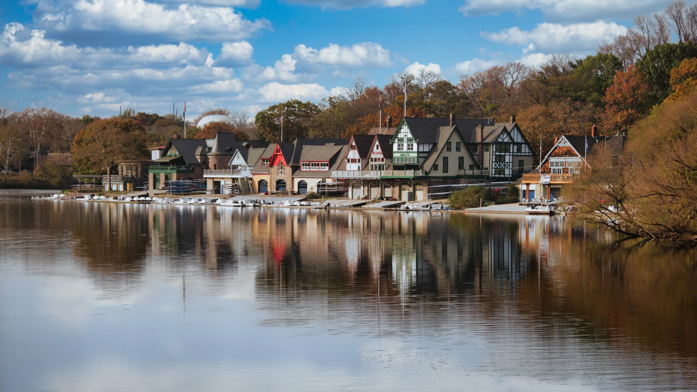 a row of houses next to a body of water at Boathouse Row in Philadelphia, PA