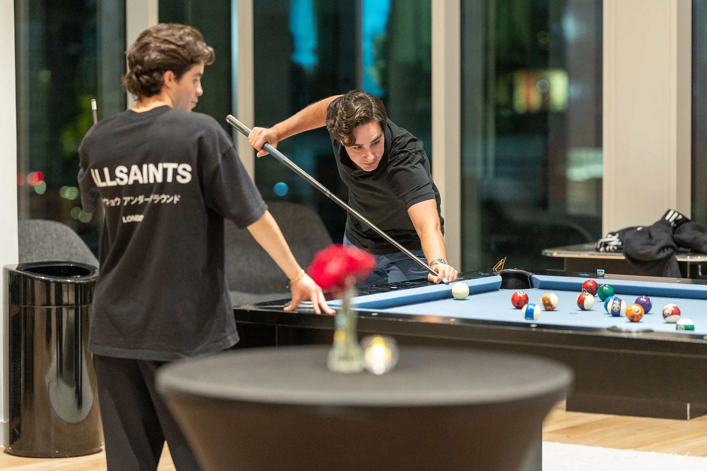 a group of people playing pool