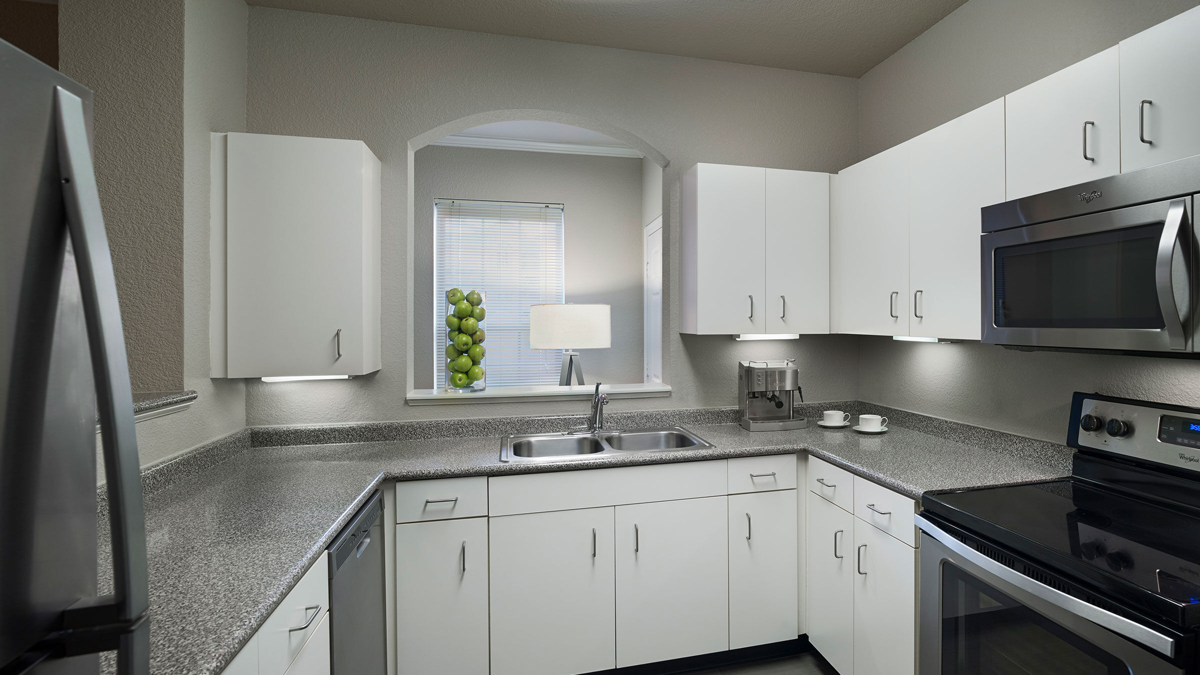 a kitchen with white cabinets and a sink