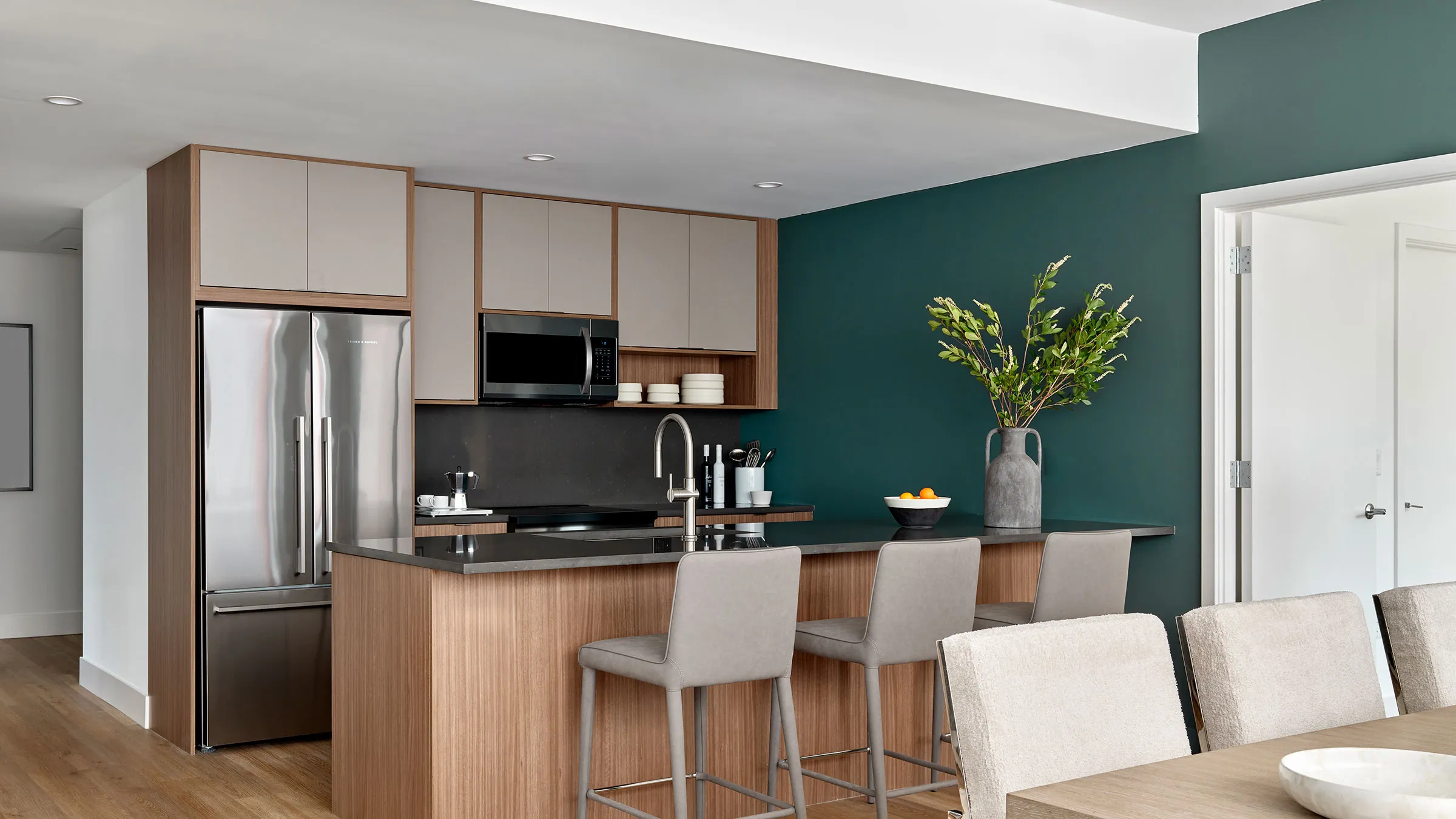 a kitchen with a bar and a refrigerator