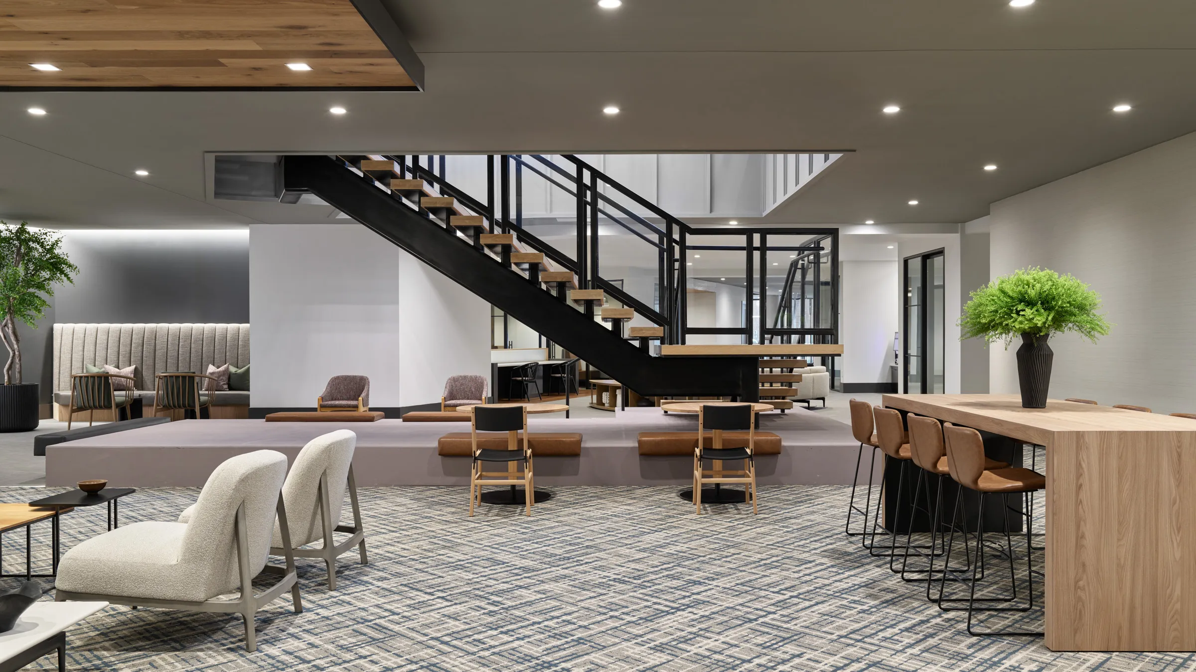 a room with a staircase and chairs