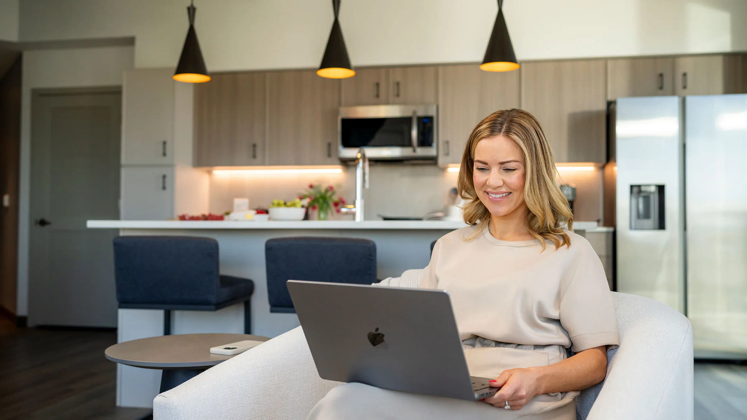 a woman sitting in a chair using a laptop