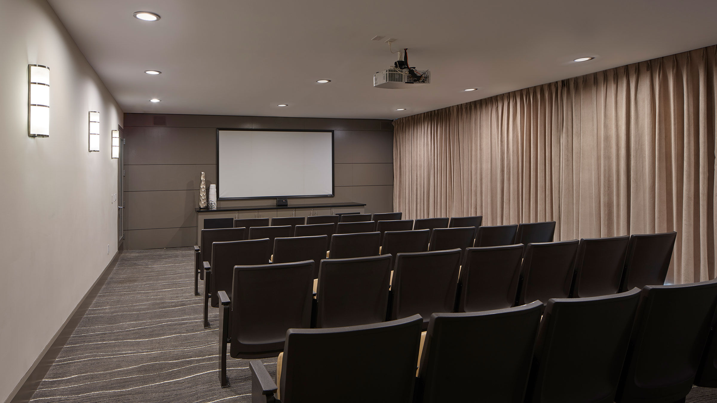 a room with chairs and a projector screen