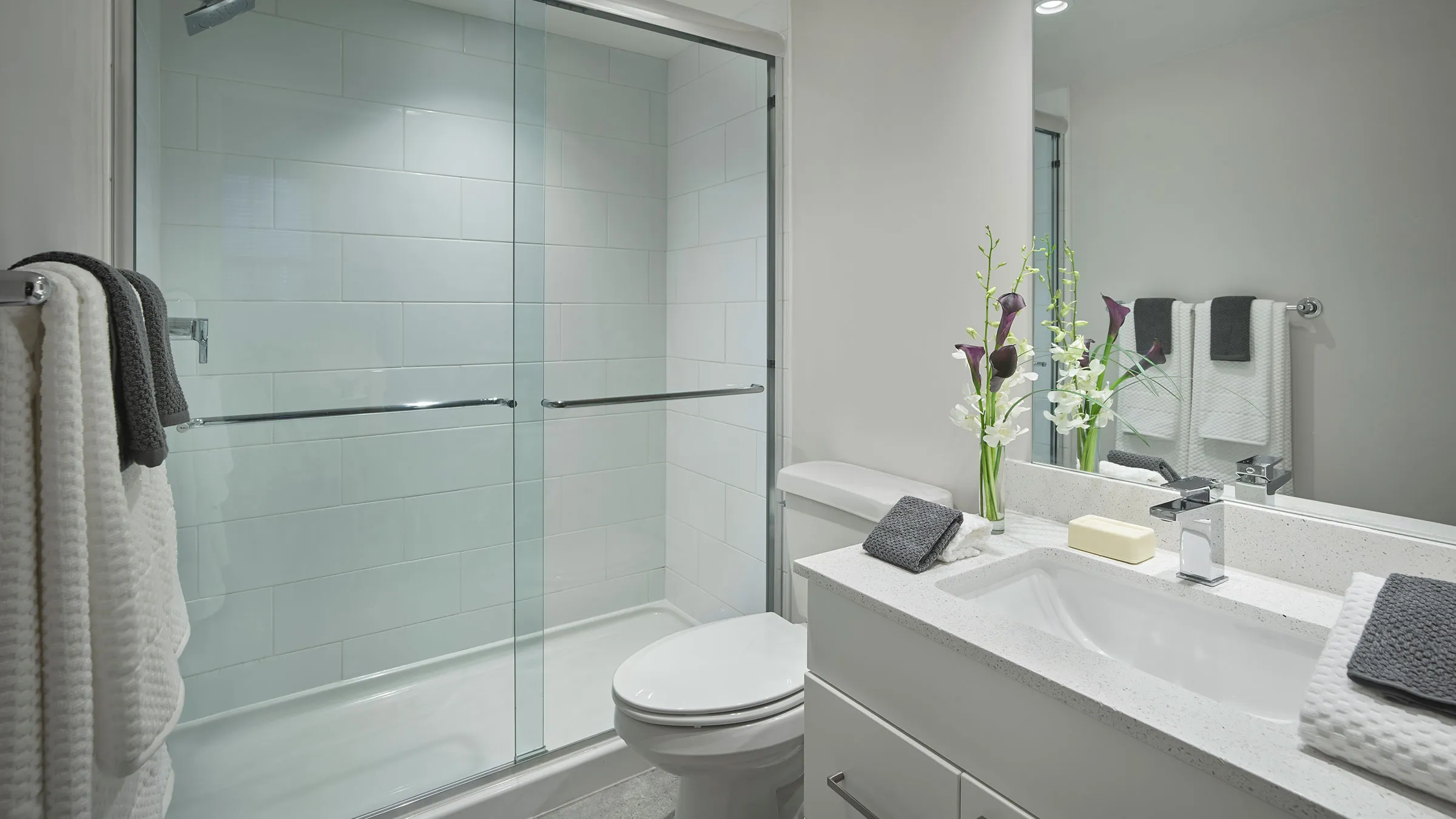 a bathroom with a glass shower and sink