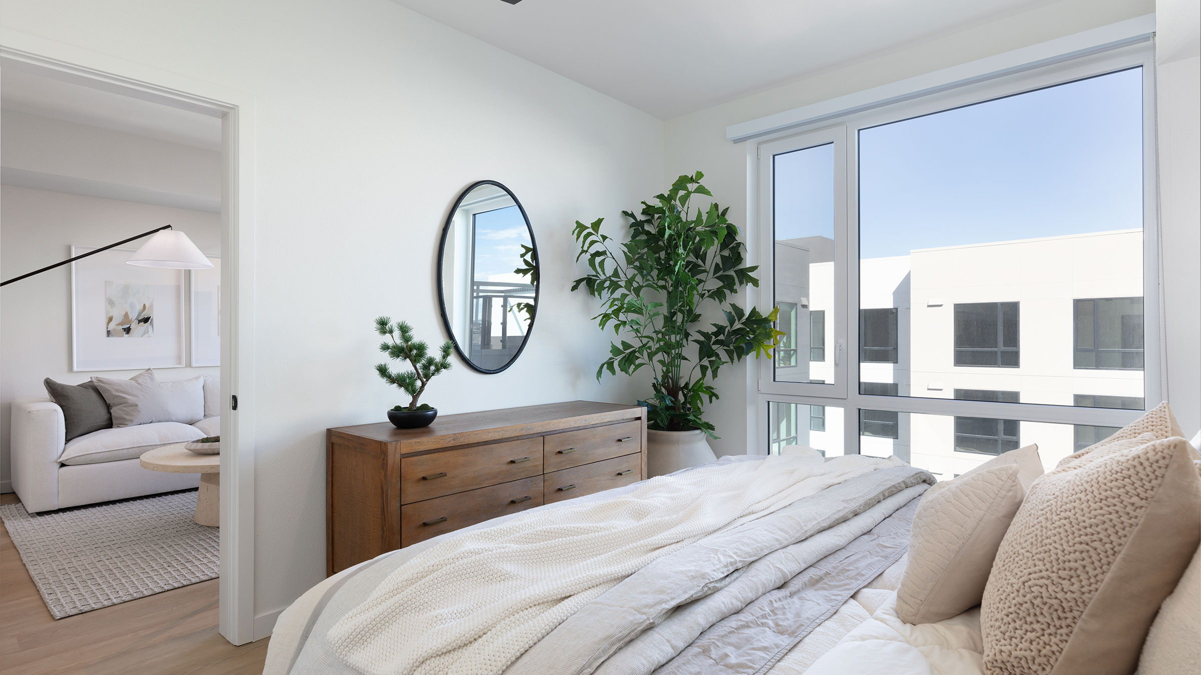 a bedroom with a mirror and a dresser