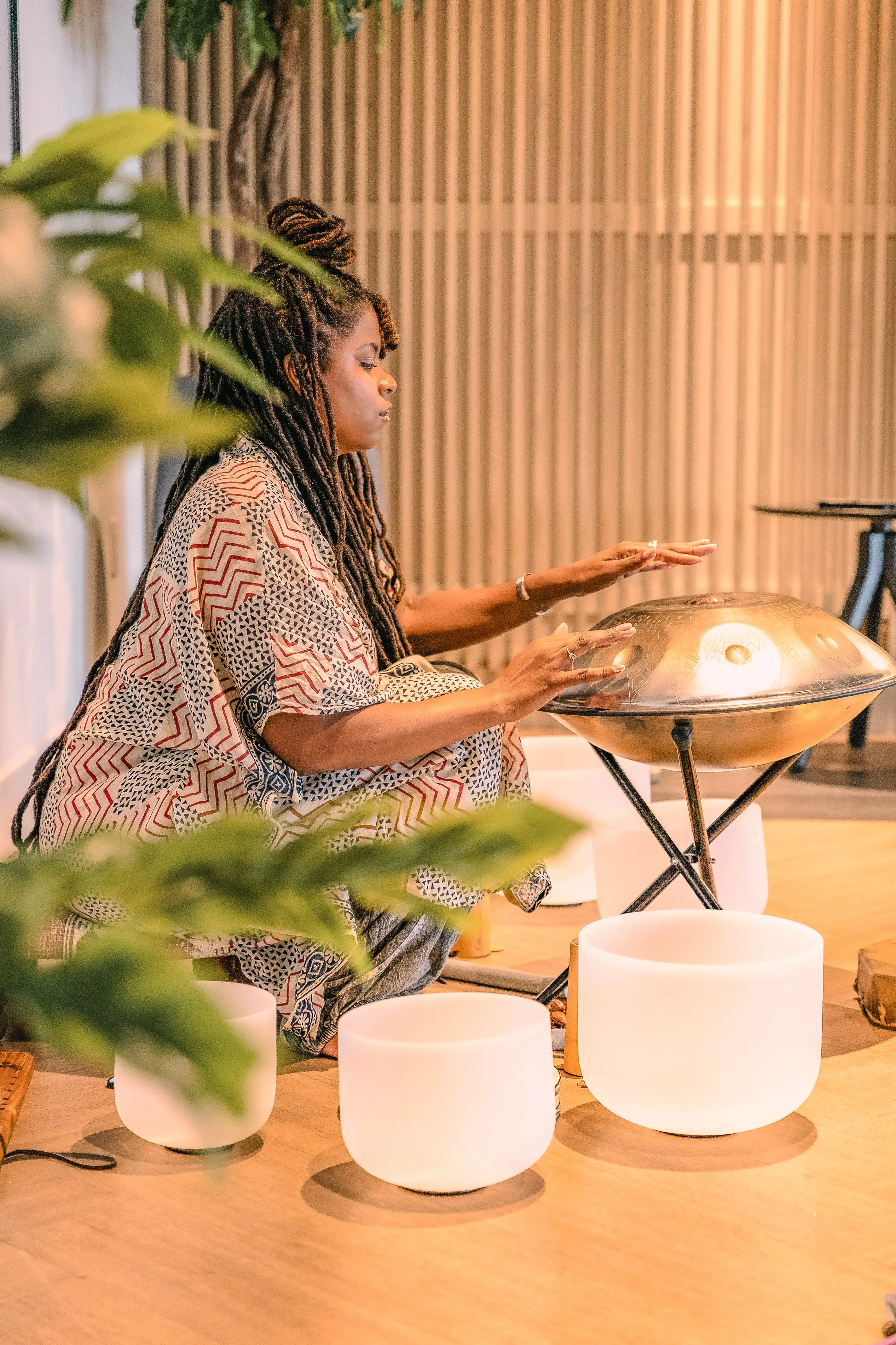 a woman playing a gong