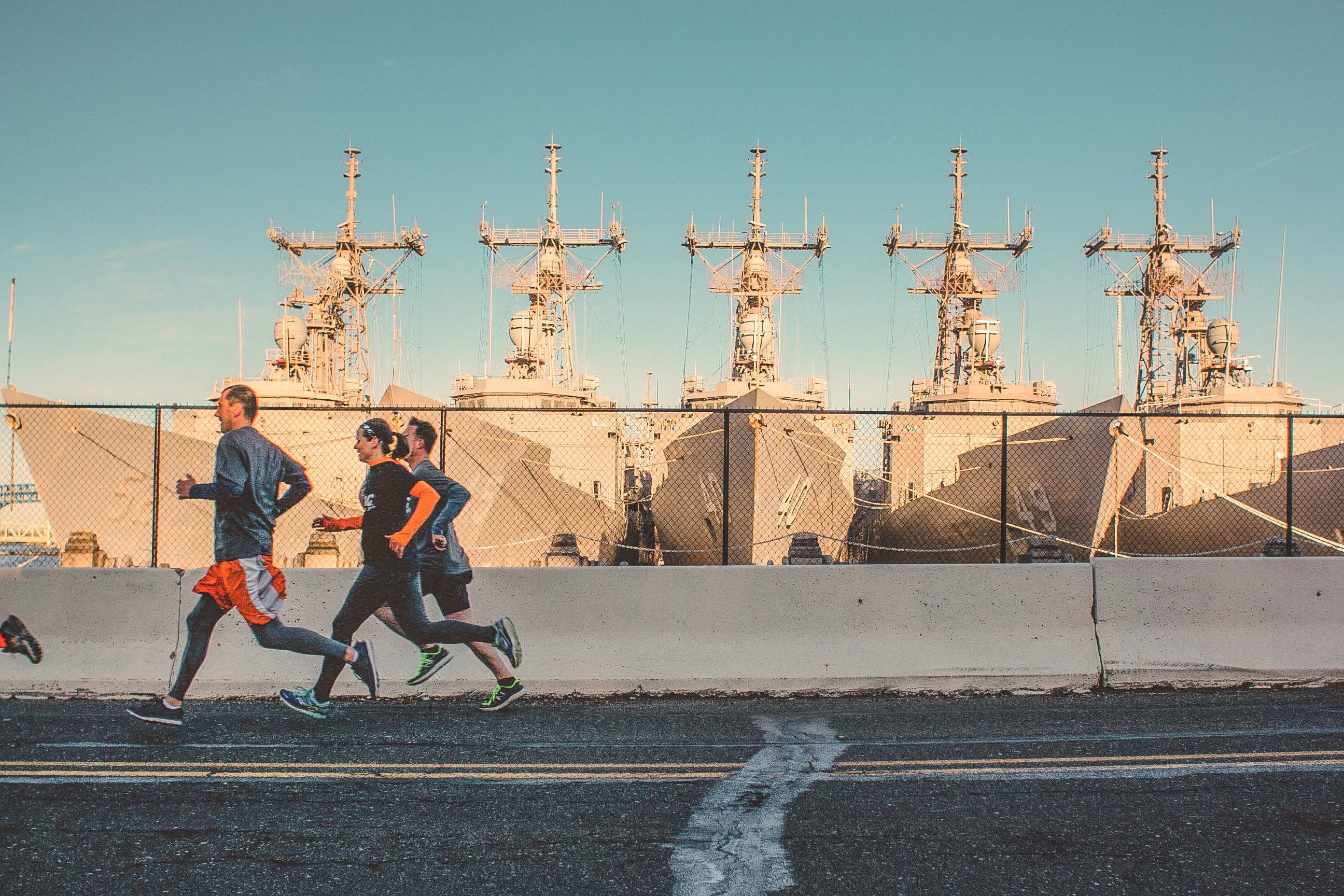 a group of people running on a road at the Navy Yard in Philadelphia, PA
