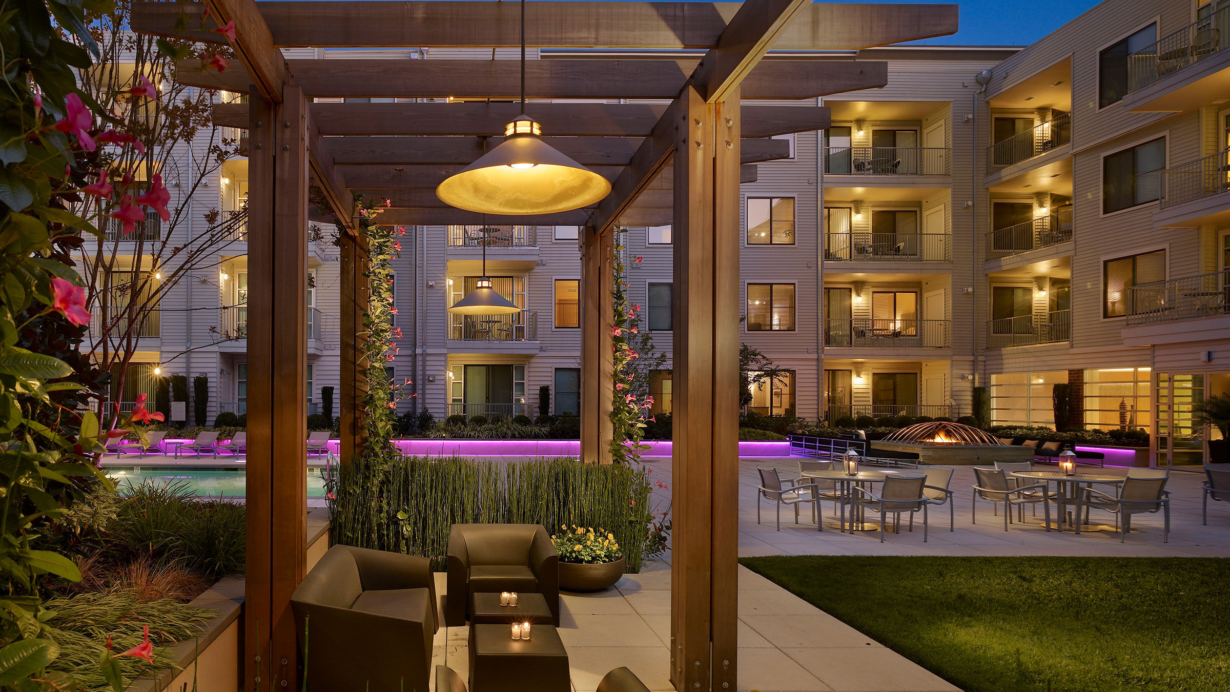 a patio area with chairs and tables and chairs in front of a building