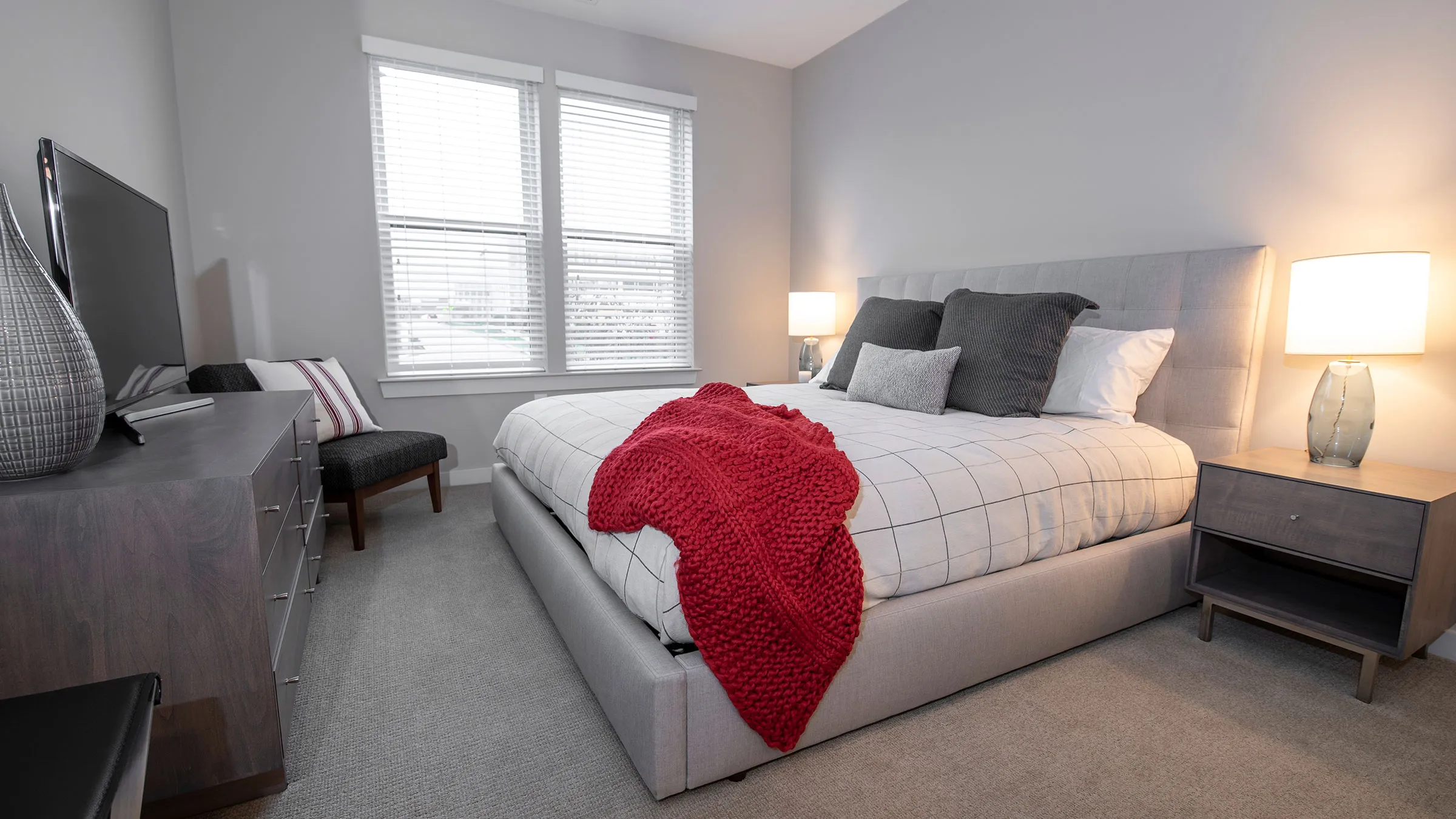 a bed with a red blanket in a bedroom