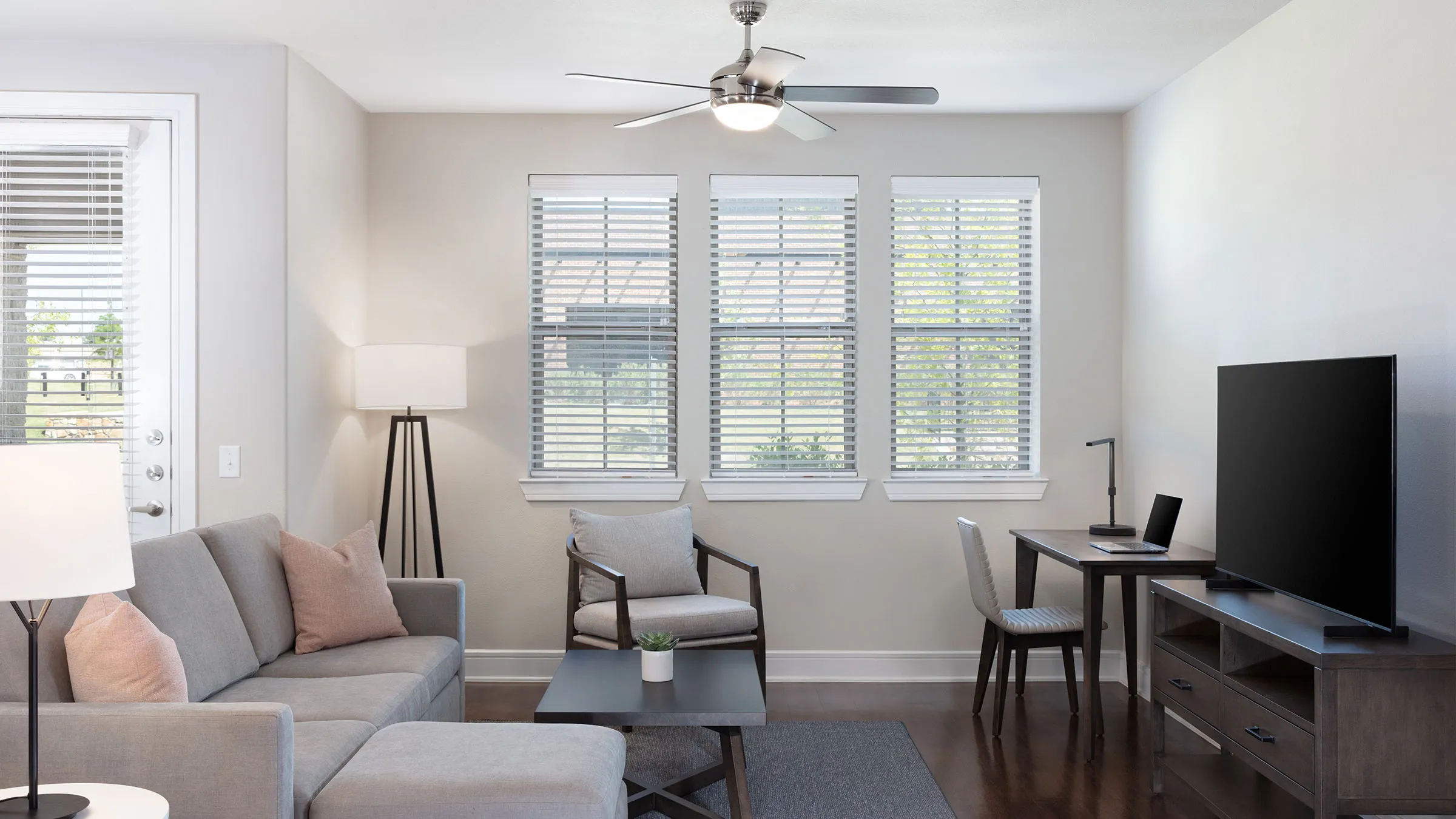 a living room with a fan and couches