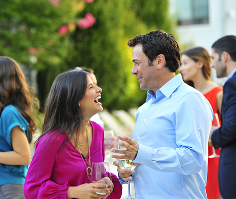Woman and man laughing at resident event 