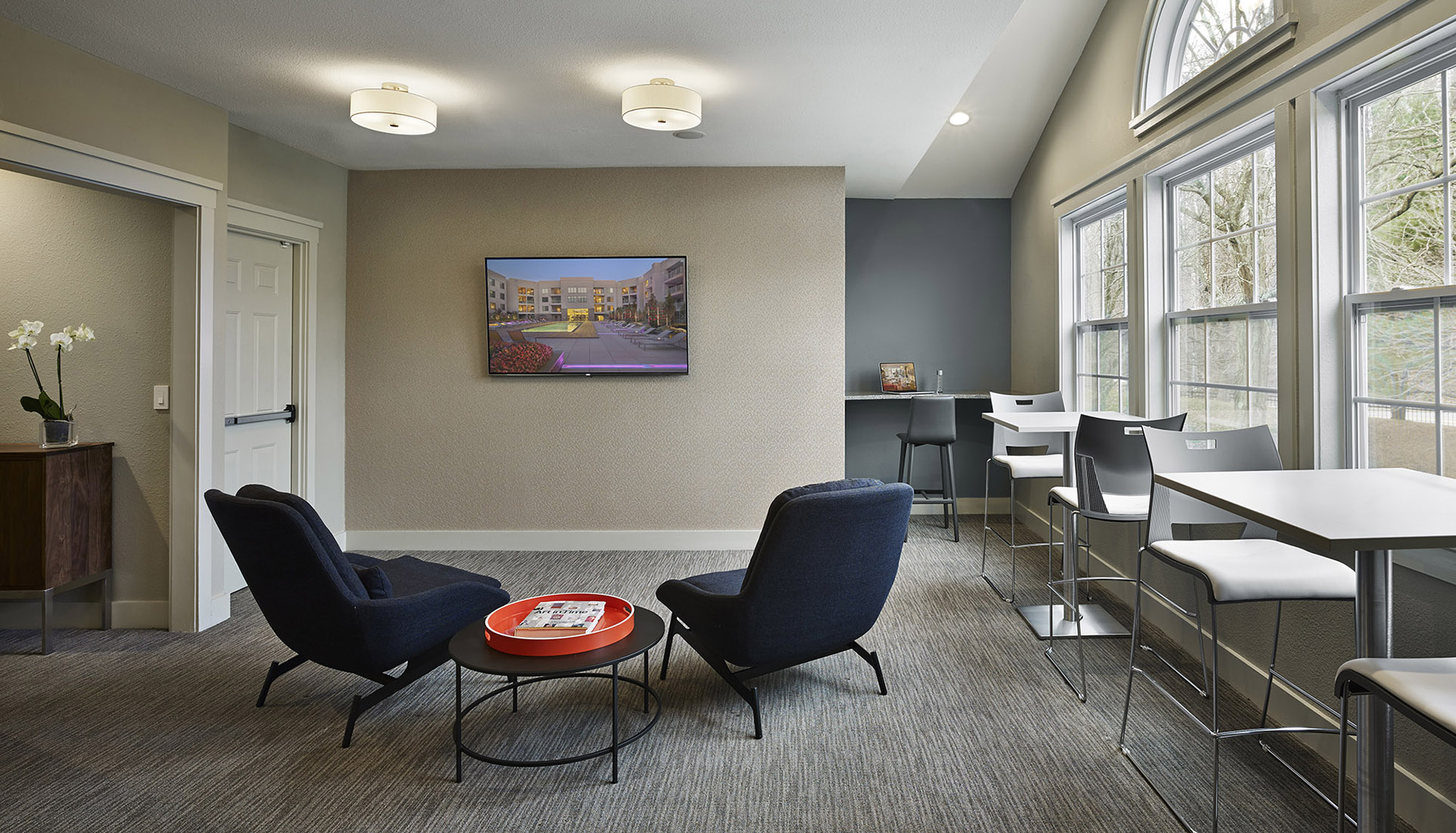 Lounge with different types of chairs and a large picture window