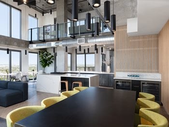 resident lounge with two story view, table areas for work spaces and relaxation