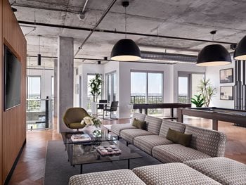resident lounge with ample seating, cream couch for relaxation or bar for work from home area