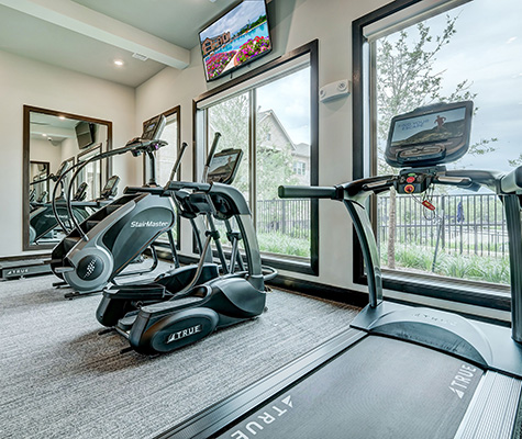 Las Colinas Fitness Center with vardio machinery and tvs
