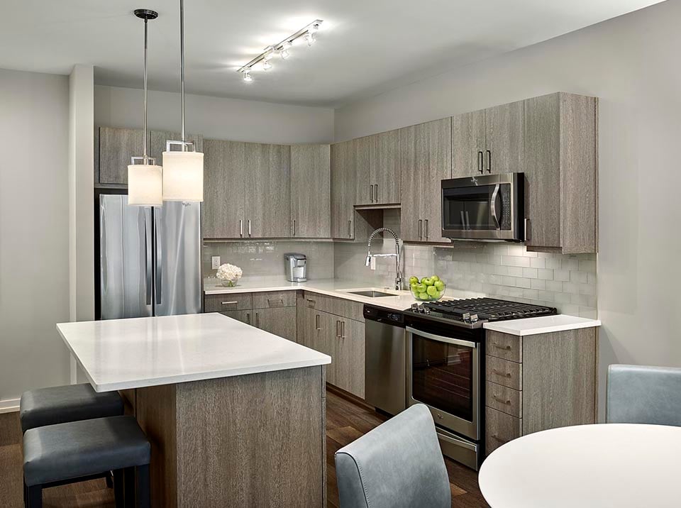 AVE King of Prussia Apartment kitchen with light gray cabinets and island