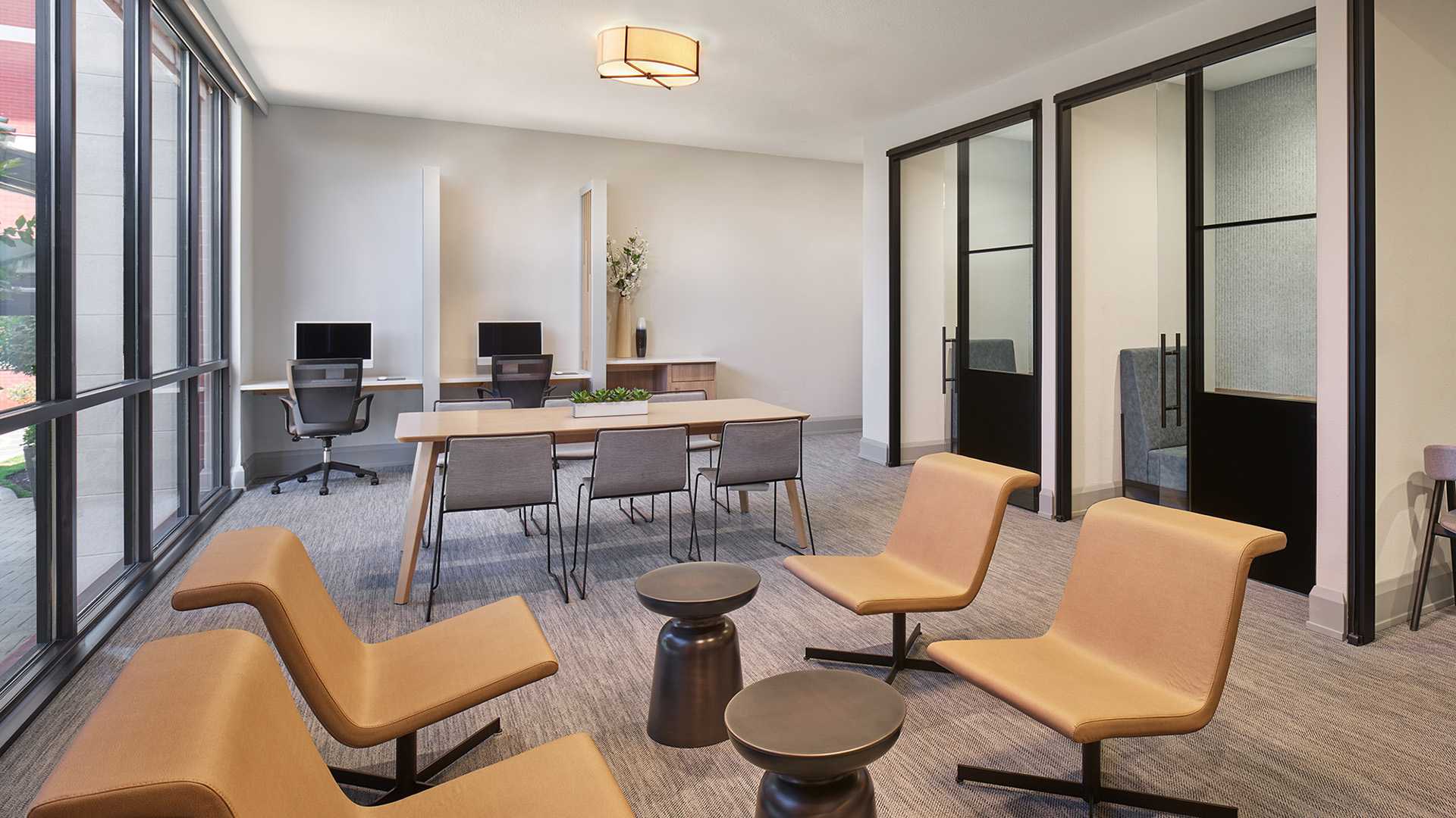 AVE Clifton business lounge with private rooms with desks and tvs 