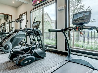 Fitness Center with cardio equiptment such as treadmills, with tvs above
