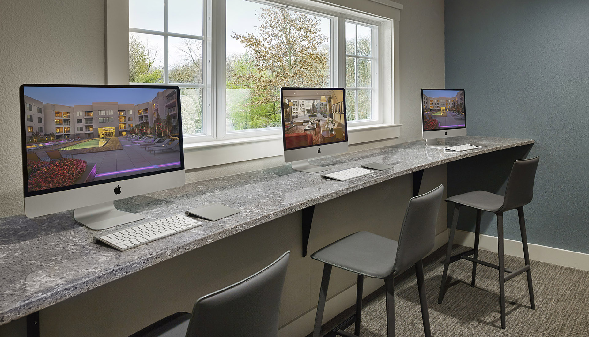 Business Center with three computers in front of a window